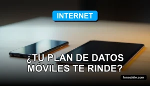 Calculadora de datos móviles mostrando gráficos abstractos de consumo en una tableta moderna sobre una mesa de madera clara.